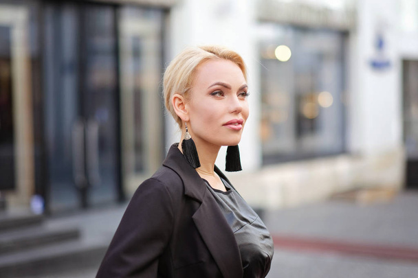 Portrait of a beautiful woman with blond hair, outdoors - Zdjęcie, obraz