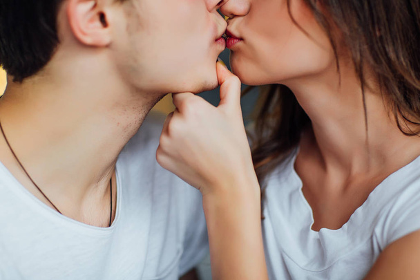 young romantic couple kissing and enjoying company of each other at home - Foto, Imagen
