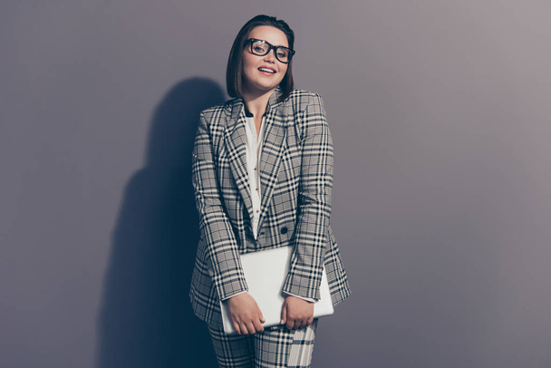 Adorable dreamy  dreamy cute charming elegant graceful pretty attractive she her woman using netbook for work wearing checkered plaid suit pants trousers isolated grey background - Foto, imagen