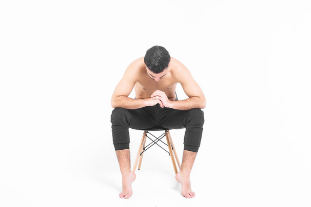 attractive man sitting on black chair isolated on white background - Φωτογραφία, εικόνα