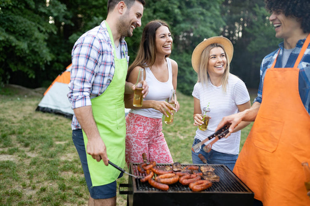 Group of friends having a barbecue party in nature - Photo, Image