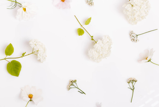 Festive flower composition on the white wooden background. Overhead view - Φωτογραφία, εικόνα