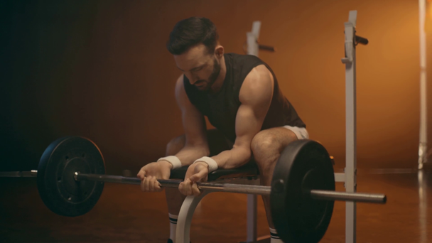 Muscular bearded powerlifter in white socks training with barbell - Footage, Video