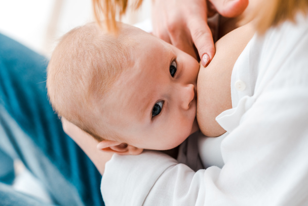partial view of woman breastfeeding baby at home - Fotoğraf, Görsel