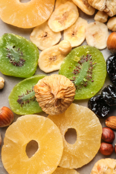 Asortyment smaczny suszone owoce i orzechy na szarym tle - Zdjęcie, obraz