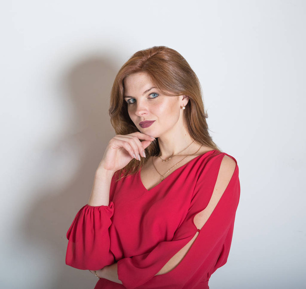 portrait of a beautiful girl with red hair in a red dress - Foto, Imagem