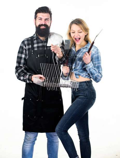 Joy of barbecue style of cooking. Pretty woman and bearded man holding cooking grate. Happy couple using cooking grid for barbecue party. Enjoy cooking food on grill - Fotó, kép