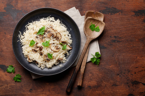 Delicious mushrooms risotto dressed with parmesan cheese and parsley - 写真・画像