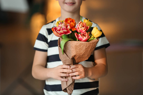 Cute boy with bouquet of beautiful flowers - Photo, Image