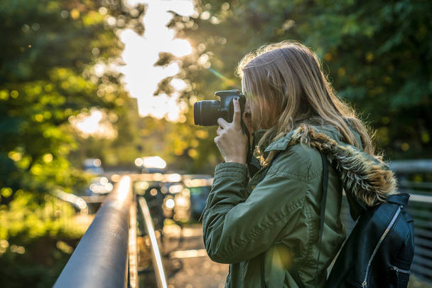 Young woman is taking a picture from the nature - Photo, Image