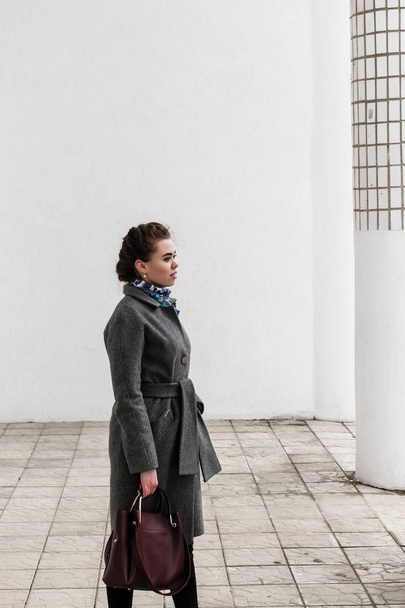Portrait in the yard. Young woman in coat. - Photo, Image