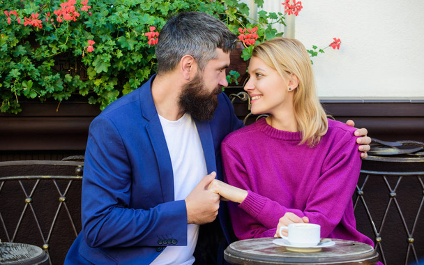 Cheerful couple. Couple in love on romantic date. First meet of girl and mature man. Brutal bearded hipster and girl drink coffee. Morning coffee. woman and man with beard relax in cafe. My couple - Photo, Image