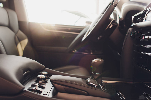 Dark luxury car Interior - steering wheel, shift lever and dashboard. - Fotó, kép