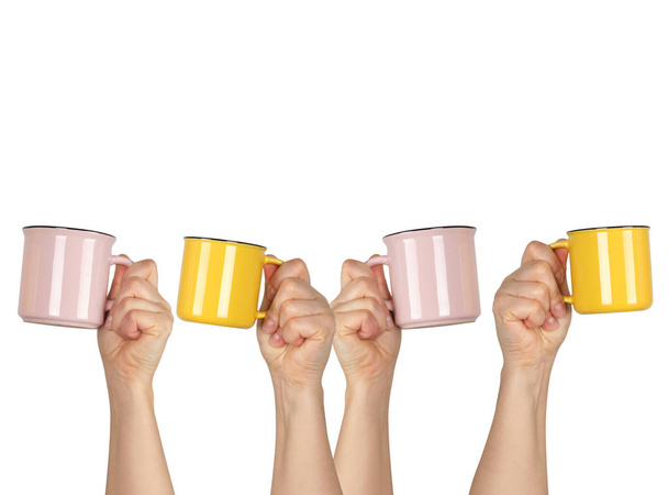 many raised hands up with ceramic cups on a white background - Photo, Image