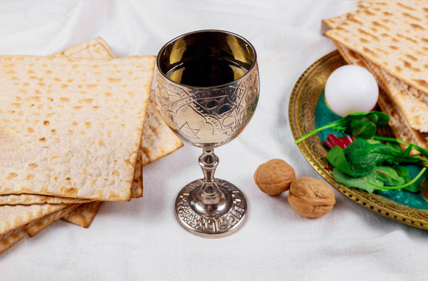 Passover matzoh jewish holiday bread, glasses kosher wine over wooden table. - Photo, Image