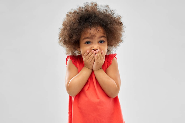 confused african american girl covering mouth - Photo, image