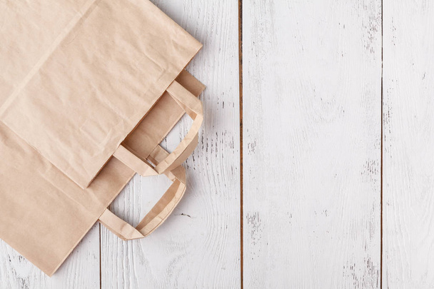 Shopping. Empty paper bags with handles, social responsibility, ecology care concept - Fotografie, Obrázek