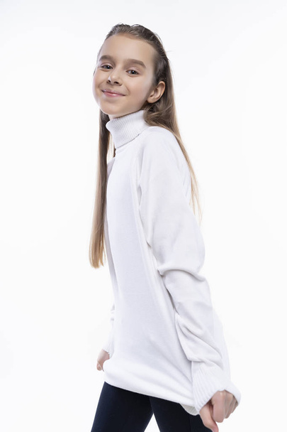 Beautiful cute teen girl wearing a white turtleneck sweater and  - Foto, imagen