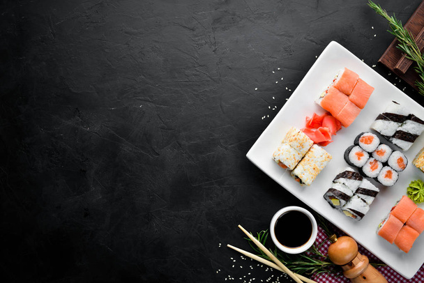 Big Set sushi with soy sauce and wasabi. Free space for your text. Top view. On a stone background. - Foto, Bild
