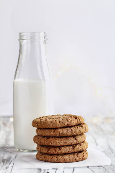 Stack of Oatmeal cookies with bottle of milk  - 写真・画像