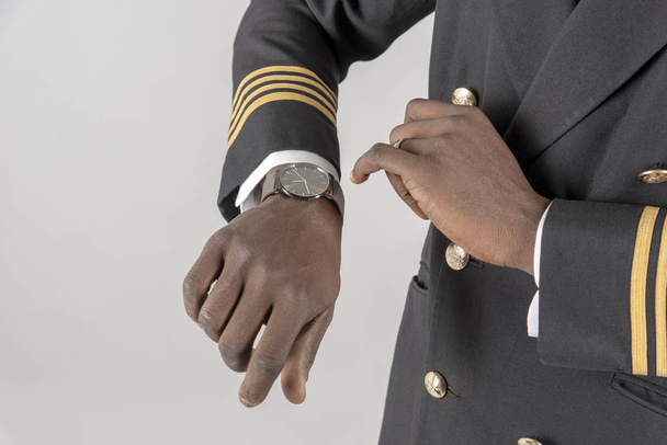  Airline pilot checking time on his wristwatch. - Φωτογραφία, εικόνα
