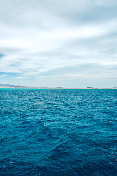 Seascape, view of the blue sea with high bald mountains in the b - Photo, Image