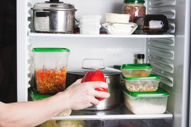 Open refrigerator with food in kitchen. Stocks of food for next  - Zdjęcie, obraz