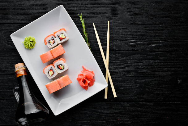 Sushi roll with seafood. Top view. On a white wooden background. - Zdjęcie, obraz