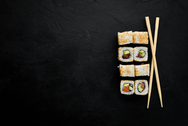 Sushi roll with fish, avocado and cucumber. Chinese traditional dish. Top view. Free copy space. - Φωτογραφία, εικόνα