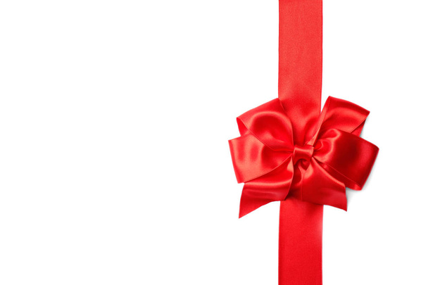 Red ribbon with bow on white background. Festive decoration - 写真・画像