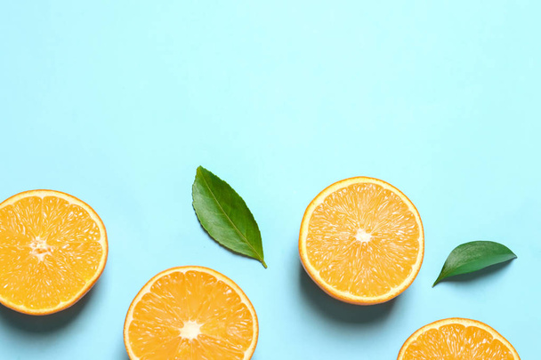 Flat lay composition with ripe oranges and space for text on color background - Fotó, kép