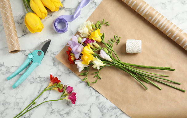 Flat lay composition with freesia flowers on table - Photo, image