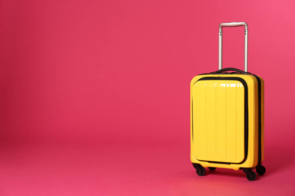 Stylish suitcase on color background. Space for text - Valokuva, kuva