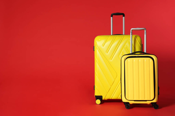 Stylish suitcases on color background. Space for text - Φωτογραφία, εικόνα