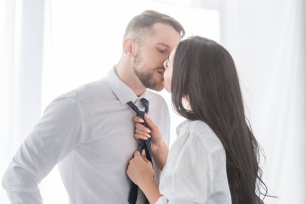 brunette woman kissing handsome boyfriend in formal wear  - Fotoğraf, Görsel