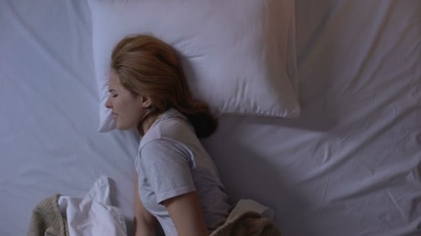 Lady feeling sharp lower abdominal pain during sleeping, suffering from cystitis - Video, Çekim