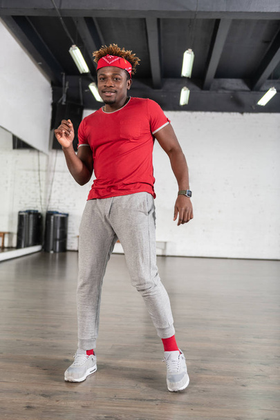 Stylish good-looking dancer wearing red and grey outfit - Fotó, kép