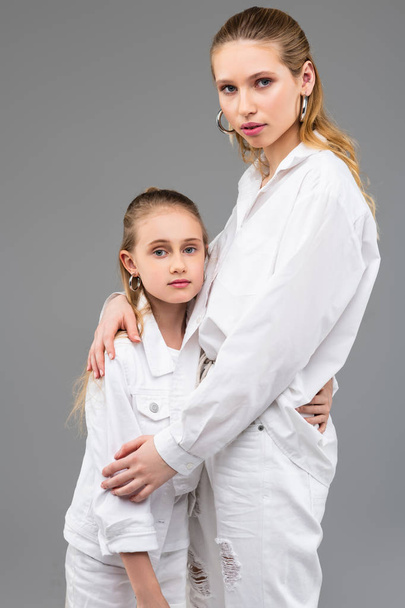 Tall long-haired girl standing with her young cute sister - Fotografie, Obrázek