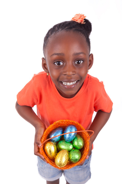 African Asian girl holding chocolate ester egg - 写真・画像