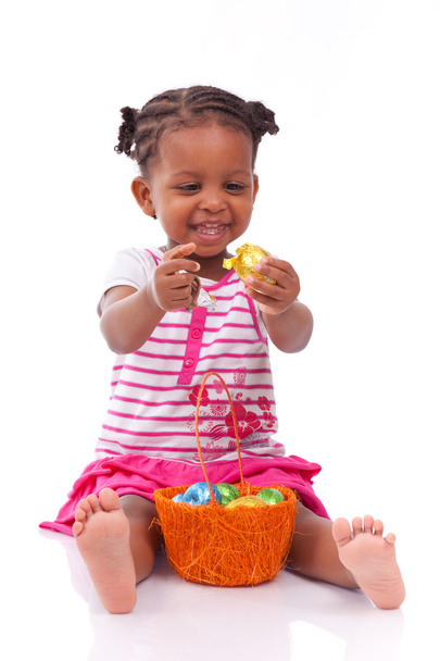 African Asian girl holding chocolate ester egg - 写真・画像