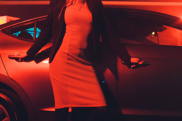 Girl standing by the cars in the red light. - Foto, Imagem
