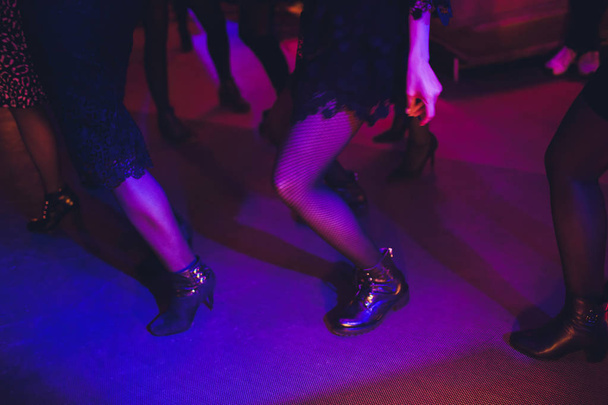 Legs of dancing people at the party. - Valokuva, kuva