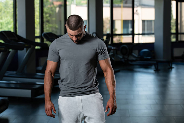 Muscular Man Posing In Gray T-shirt - Foto, immagini