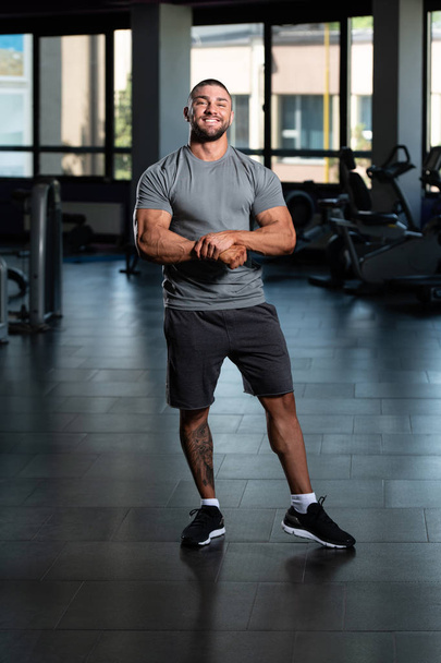 Muscular Man Posing In Gray T-shirt - Photo, image