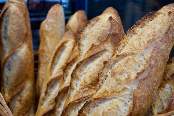 Baguettes standing upward in a basket at a Dutch bakery, ready t - Photo, Image