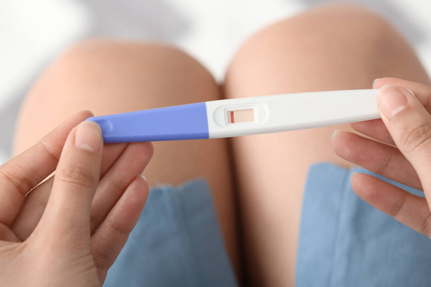 Woman with pregnancy test, closeup - Fotó, kép