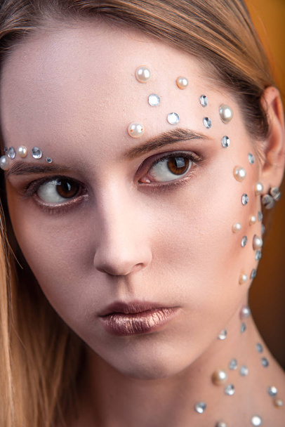Girl with white and pearl rhinestones on her face. - Fotografie, Obrázek
