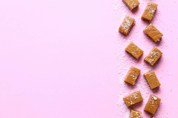 Tasty candies with salt on color background - Foto, Imagem