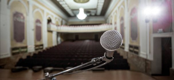 Microphone over the Abstract blurred photo of conference hall or seminar room background - Photo, Image
