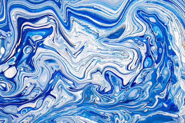 Hand painted background with mixed liquid blue, white, yellow paints. Abstract fluid acrylic painting. Applicable for packaging, invitation, textile, wallpaper, design of different surfaces - Photo, image